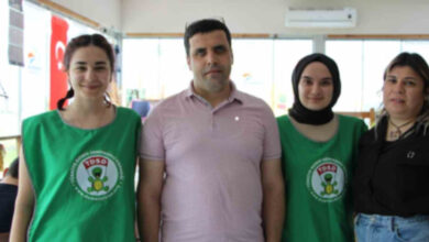 Engelliyim Engel Tanımam Derneği Başkanı Kamil Göçmen ve görevli üç kadın ile birlikte ayakta.