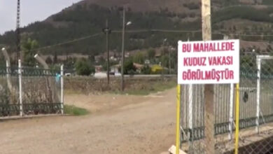 Bir mahallenin girişinde asılı olan tabelada "Bu mahallede kuduz vakası görülmüştür." yazıyor.