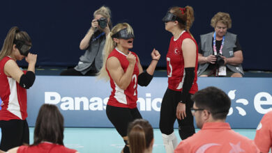 Golbol Kadın Milli Takımı, gözlerinde siyah bant takılı şekilde galibiyet sevincini iki kollarını yukarı kaldırarak ve çığlık atarak gösteriyorlar.