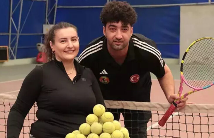 Esra Bozdemir Işık ve eşi Ömer Işık tenis filesinin yanında birbirlerine omuz omuza duracak şekilde poz veriyorlar.