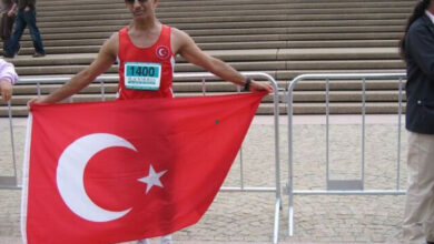 Görme engelli dağ sporcusu Necdet Turhan Türk bayrağı açarak fotoğraf için poz veriyor.