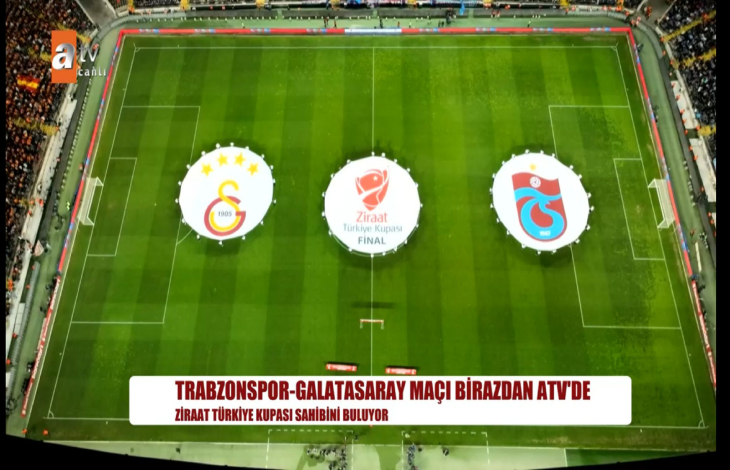 Kuş bakışı fotoğrafta sahada büyük boyutta solda Galatasaray, ortada Türkiye Ziraat Kupası ve sağda Trabzonspor amblemli flamaları bulunuyor.