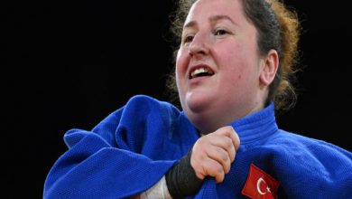 Görme engelli judocu Nazan Akın Güneş gururla formasındaki ay yıldız bayrağı tutuyor.