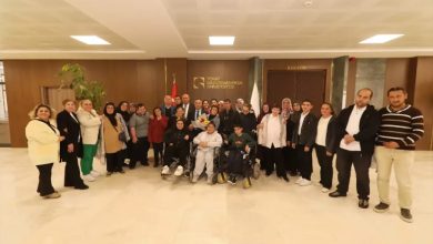 Türkiye Sakatlar Derneği Tokat Şubesi yönetimi, engelli bireyler ile Tokat Gaziosmanpaşa Üniversitesi Rektörü Prof. Dr. Fatih Yılmaz fotoğraf çektiriyor.