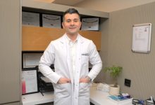 Görselde, Özel Sağlık Hastanesi Fizik Tedavi ve Rehabilitasyon Uzmanı Dr. Arman Öztürk ayakta duruyor ve elleri üniformasının cebinde.