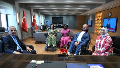 Bakan Uraloğlu, makamında misafir koltuğunda oturuyor ve karşısında bulunan milli boccia sporcuları Emre ve Fulya Vural ile birlikte, farklı sporcuların da yer aldığı buluşmada, makam odasında toplu hatıra fotoğrafı çekiliyor.