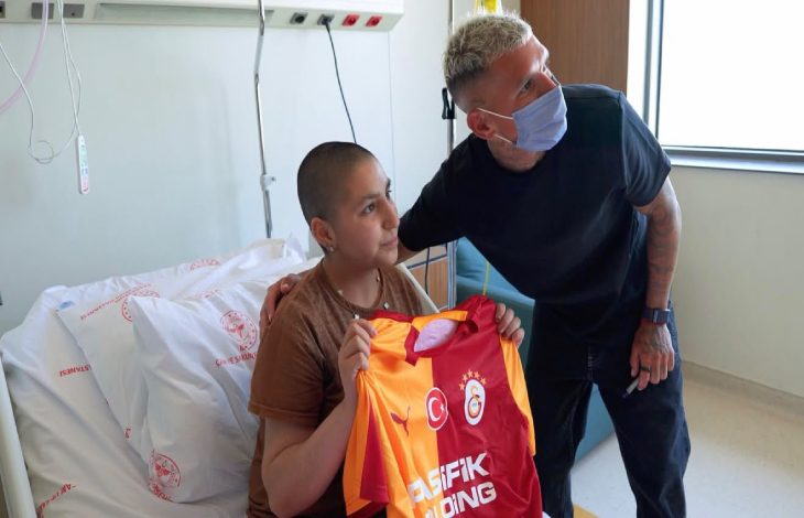 Galatasaray'lı Futbolcu Lucas Torreira, forma hediye ettiği tedavi gören gençle fotoğraf çektiriyor.