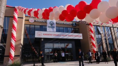 Kırmızı ve beyaz balonlarla süslenen Karatay Engelli Aktif Yaşam Merkezi'nin giriş cephesi, açılış organizasyonu kapsamında hazırlanan tören alanı ve katılımcılarla birlikte görüntülenmektedir.