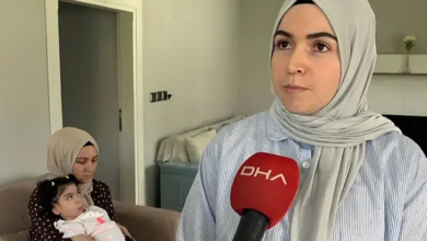 Görselde, açık renk başörtülü bir kadın DHA mikrofonuna konuşuyor. Arka planda koltukta oturan başka bir kadın, kucağında bir bebeği tutuyor.