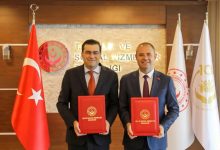 Aile ve Sosyal Hizmetler Bakanlığı Engelli ve Yaşlı Hizmetleri Genel Müdürü Taha Kürşad Sezen ile Kırklareli Belediye Başkanı Derya Bulut, ayakta durarak protokolleri ise ellerinde tutarak poz veriyor.