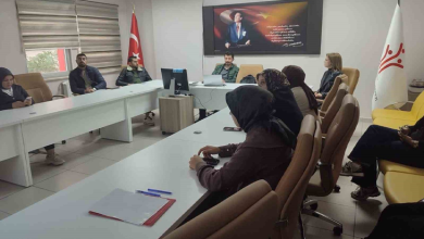 Instagram İçin Alternatif Metin: Görselin üst bölümünde, kurumsal bir toplantı odasında U şeklinde dizilmiş beyaz masaların etrafında oturan Engelli ve Yaşlı Hizmetleri personeli yer alıyor. Masalarda not dosyaları, kalemler ve bilgisayarlar bulunurken; başörtülü ve takım kıyafetli kadın ile erkek personeller dikkatle toplantıyı takip ediyor. Odanın baş tarafındaki duvarda Atatürk portresi ve vecizesi asılı duruyor; köşede Türk bayrağı ile sağ tarafta Aile ve Sosyal Hizmetler Bakanlığı'nın logosunu taşıyan beyaz bayrak görülüyor.